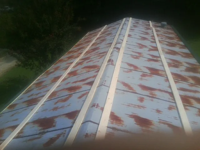 Rusted metal roof panels with new wood purlins before replacement — Storm Damage Roof Repair in Southington by Roofing Brothers