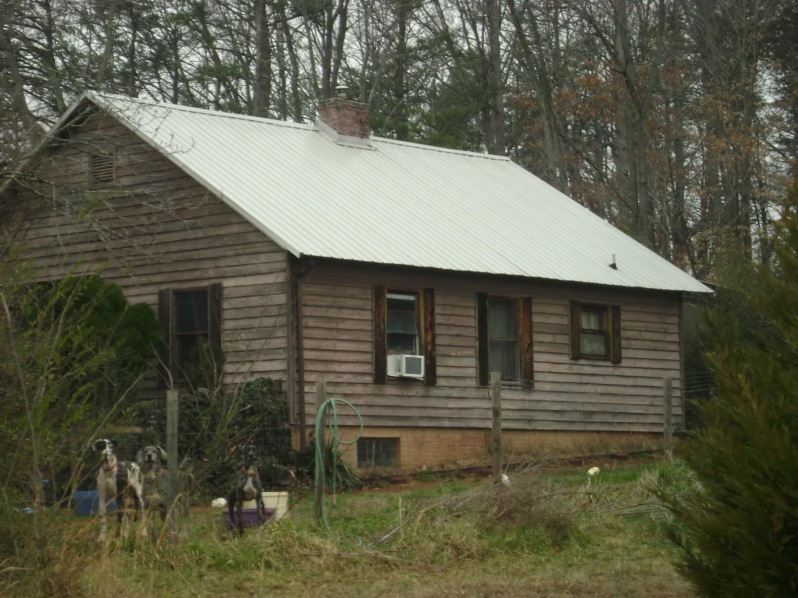 White metal roof on an old wood sided farmhouse, from a Metal Roof Installation job in Southington